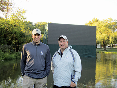 From left, Brett Amman, manager, GoVision Golf, and Chris Curtis, president of GoVision, in front of the LED screen between holes 15 and 16, which was built on a pond.