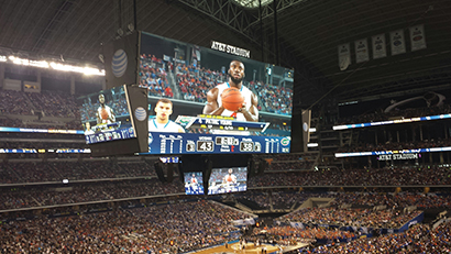 GoVision constructed and suspended four massive LED screens beneath the 60-yard-long video screens at AT&T Stadium's (a.k.a. Cowboys Stadium) to let fans seated courtside at the 2014 NCAA's Final Four basketball championships watch replays and see the scoreboard.