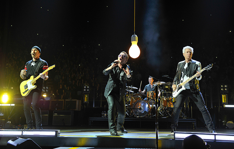 U2 opened the show wiith a single lightbulb over Bono. 2015 tour photo by Steve Jennings