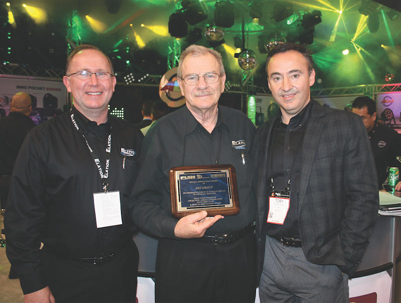 Timeless Communications, parent company to PLSN magazine, presented a plaque commemorating ADJ’s 30 years at Winter NAMM 2015. Pictured from left are Eric Loader, Chuck Davies and Toby Velazquez.