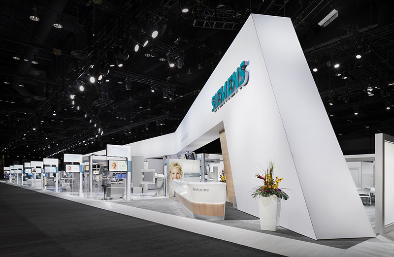 The booth design featured a banner requiring a bright, even wash of white light. Photo courtesy Siemens.