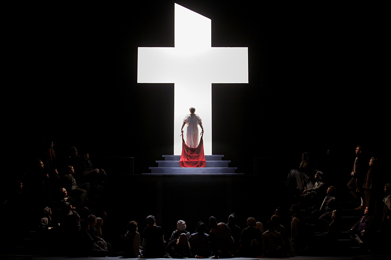 In the dramatic last moments of Dialogues of the Carmelites at Eastman Opera, Blanche makes her way to the guillotine bathed in the light of the cross. Photo by Nic Minetor