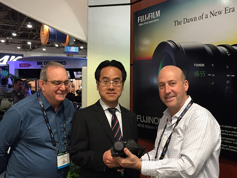 LMG Vice President of Technology Neil Morrison, FUJIFILM Optical Devices Division President Shingo Harada, and LMG CEO/President Les M. Goldberg shown with the new FUJINON UA18x5.5B 4K compatible, Ultra HD, handheld zoom in the FUJIFILM NAB 2017 booth.