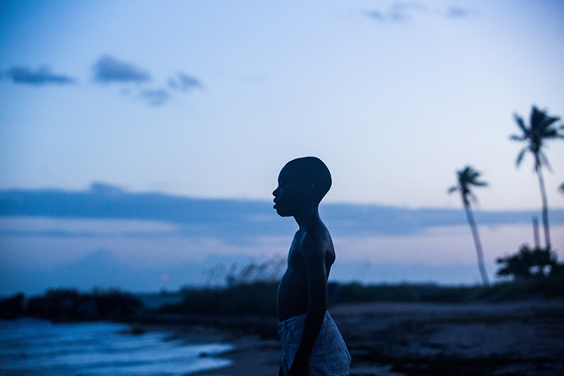 Little (Alex R. Hibbert) stands ready for an ocean swim at Miami’s magic hour.